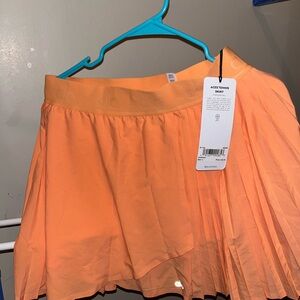 ALO Yoga Orange Pleated Skater Mini Skirt